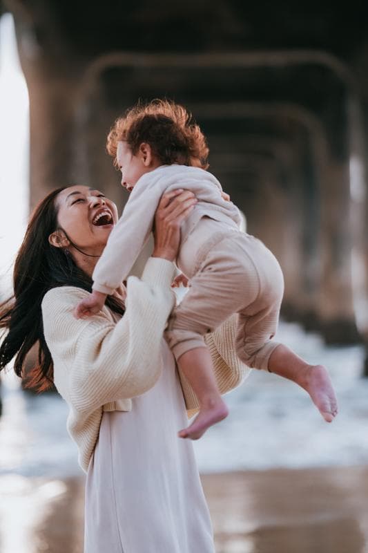 Family walking on beach at sunset